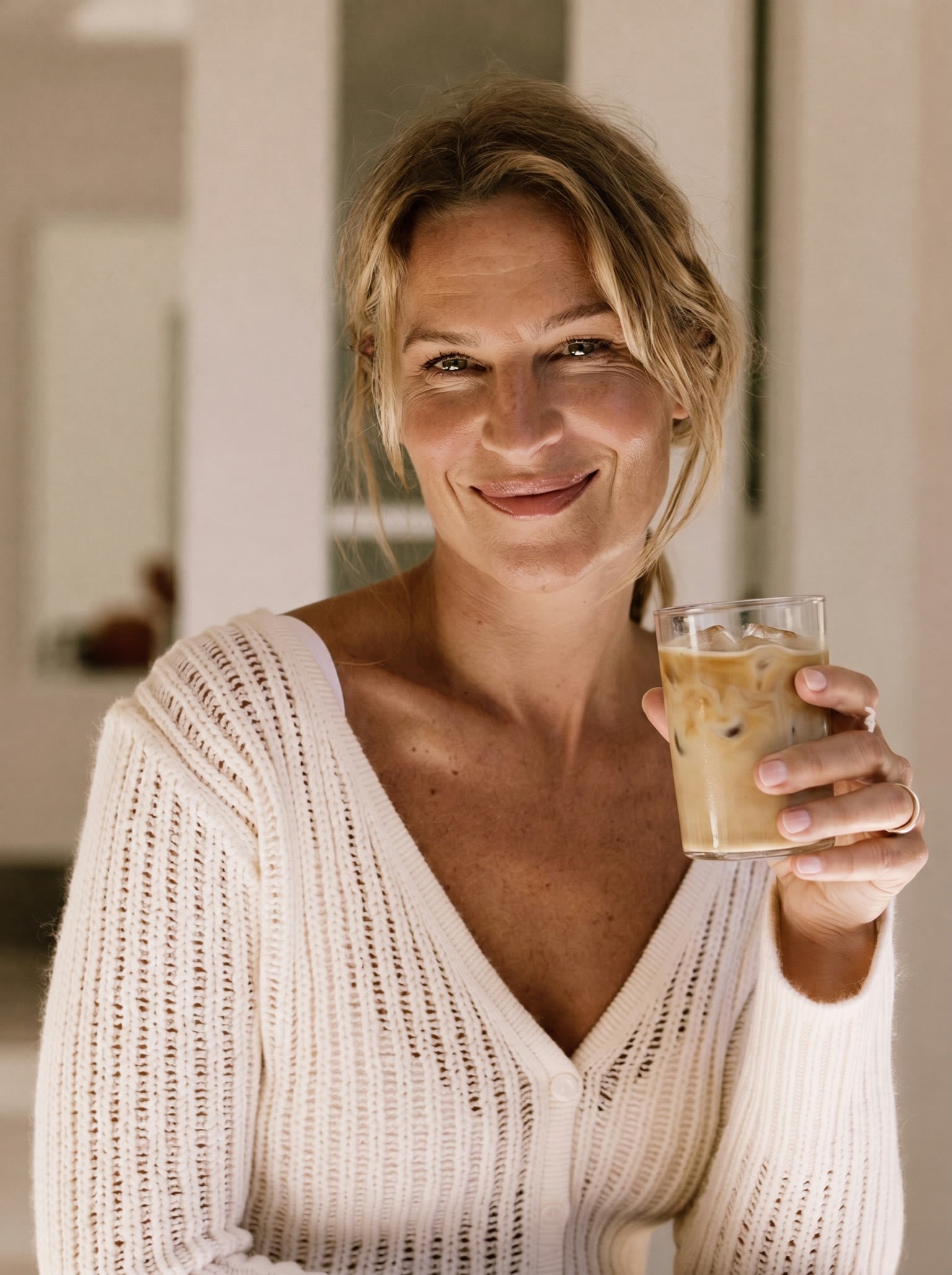 Woman feeling clear and refreshed with a glass of water